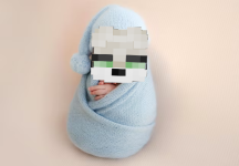 newborn-baby-boy-swaddled-in-blue-fabric-sleeping-infant-child-kid-resting-during-studio-photo...png